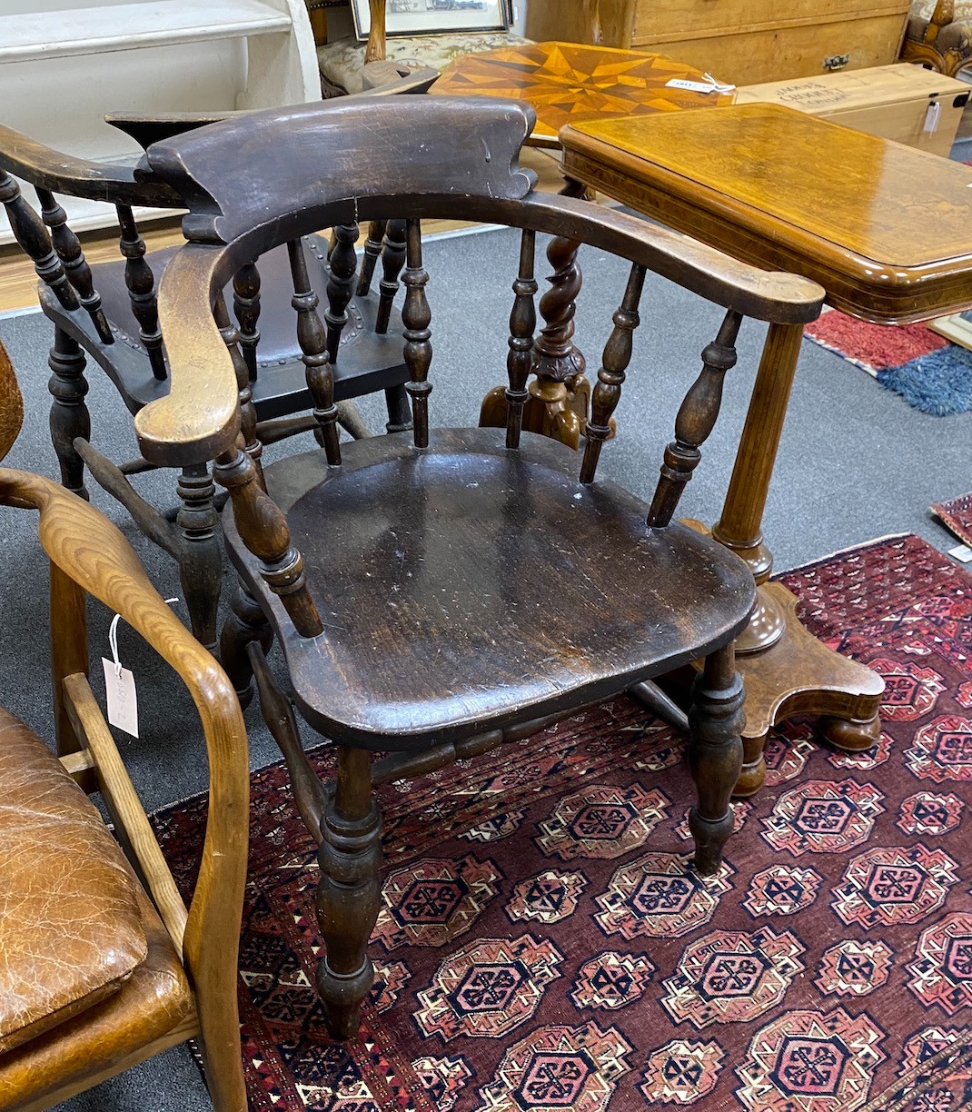 A pair of late Victorian beech and elm smoker's bow elbow chairs, width 67cm, depth 51cm, height 84cm